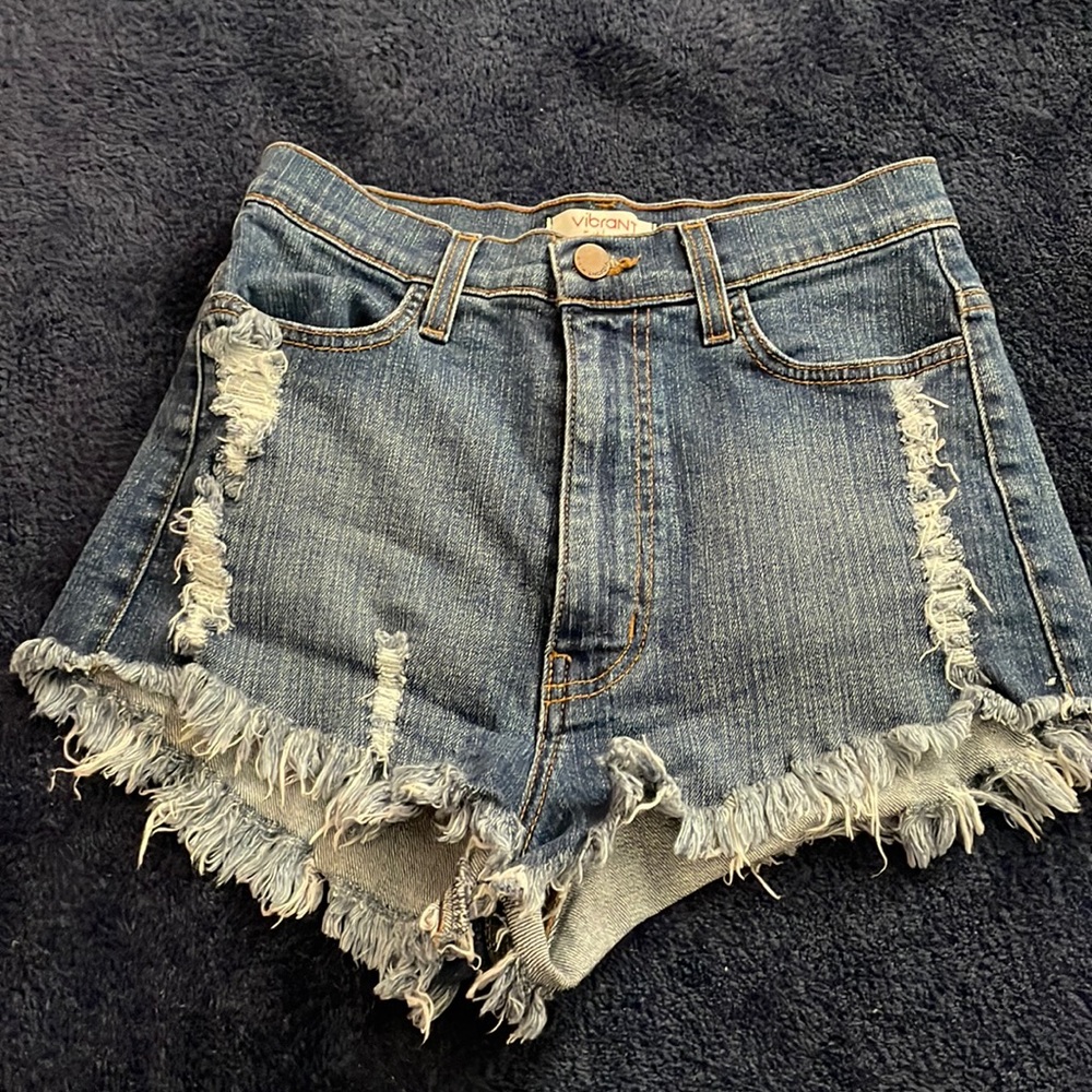 Dark wash denim shorts with distressed back pocket
